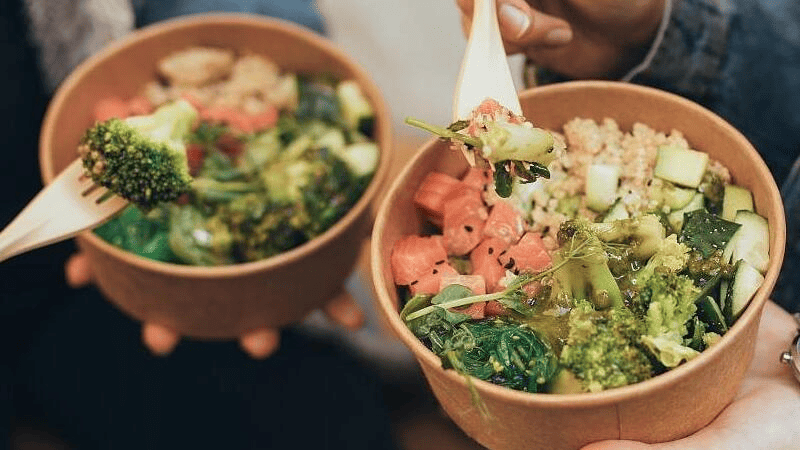 Brown paper bowls with wooden spoon