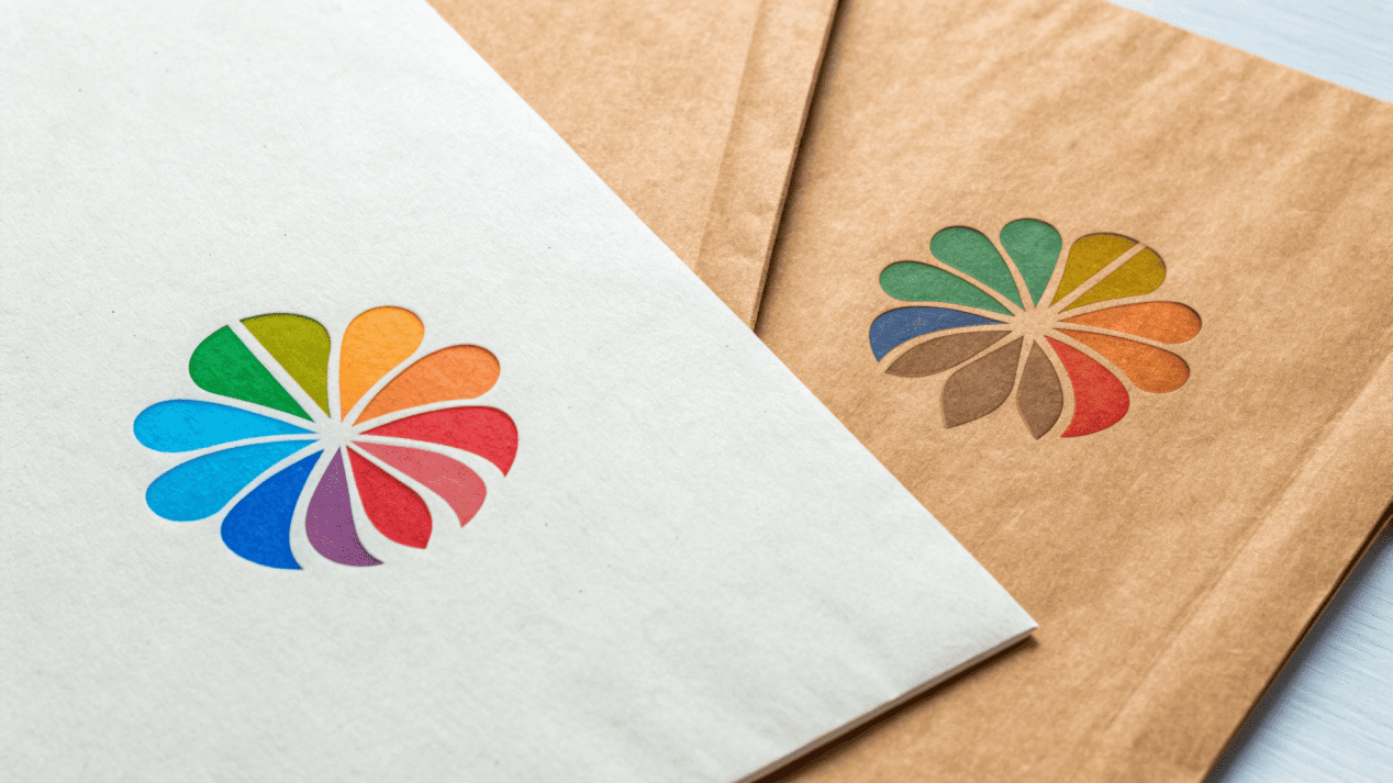 A side-by-side comparison of a logo on white paper versus on Kraft paper