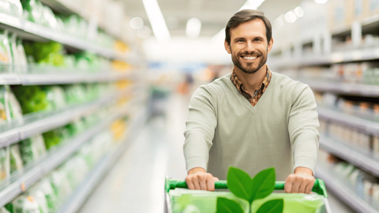 A customer in a store choosing a product with PLA packaging over a competitor's standard plastic packaging