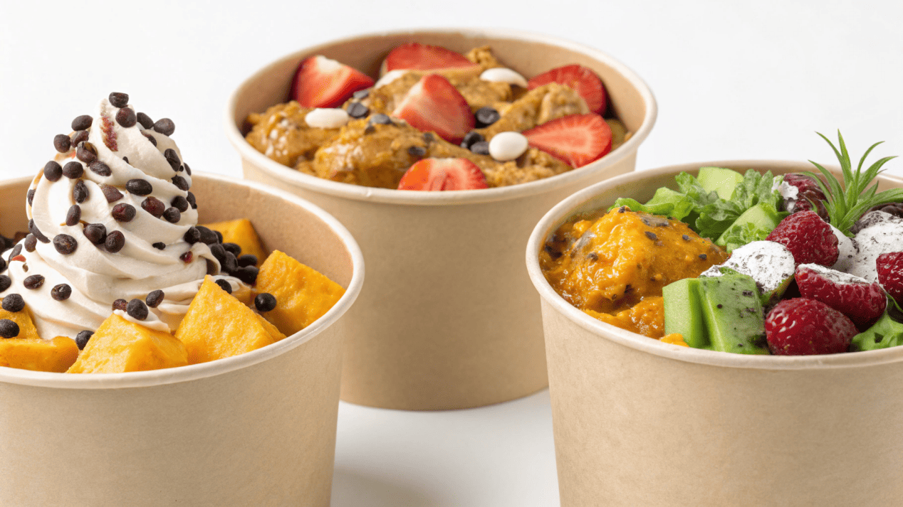 A collage of different foods served in heavy-duty paper bowls, like curry, salad, and frozen yogurt