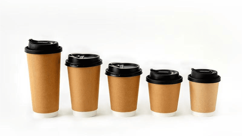 paper cup in a recycling bin with a cross mark