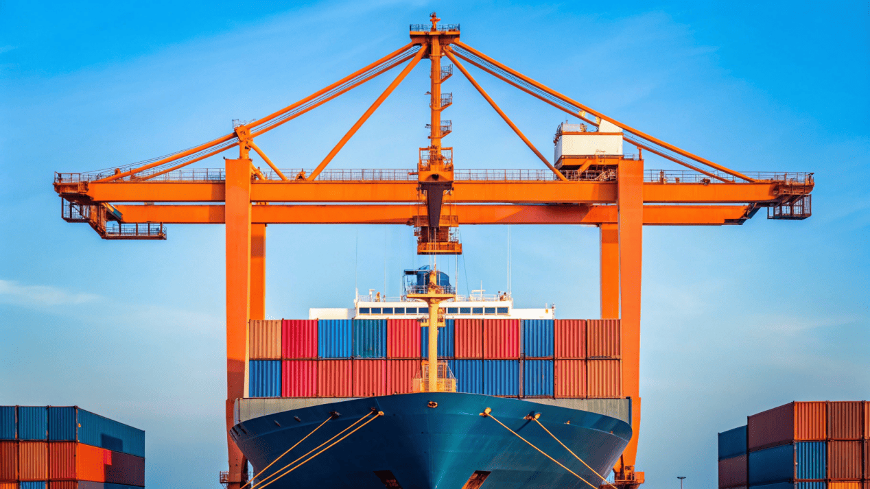 A shipping container being loaded onto a cargo ship, representing global export markets
