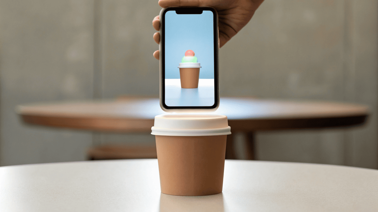 Interactive and Phygital Ice Cream Packaging A smartphone pointing at an ice cream lid, showing an AR animation of swirling flavors on the screen