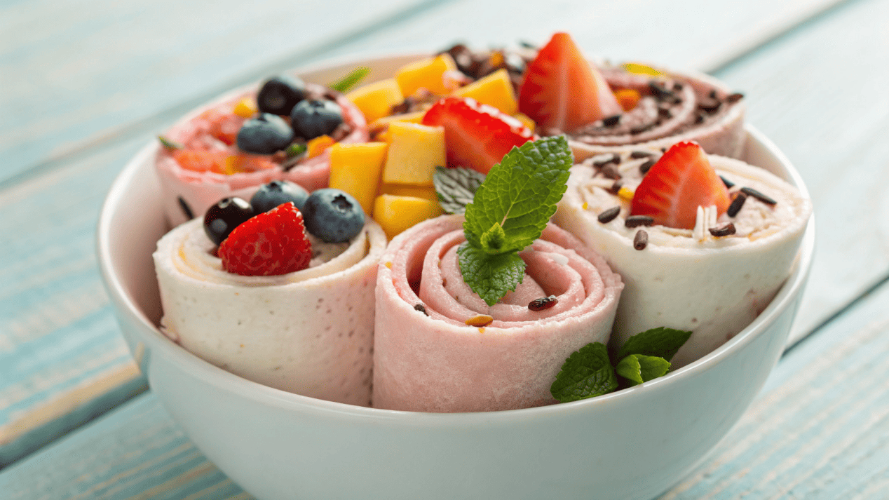 Instagrammable Ice Cream Presentation A beautifully presented bowl of rolled ice cream with many colorful toppings.