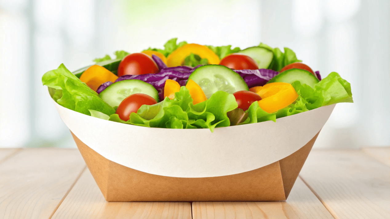Sustainable Food Packaging with Paper Bowls A fresh, colorful salad served in a custom-branded, eco-friendly paper bowl.