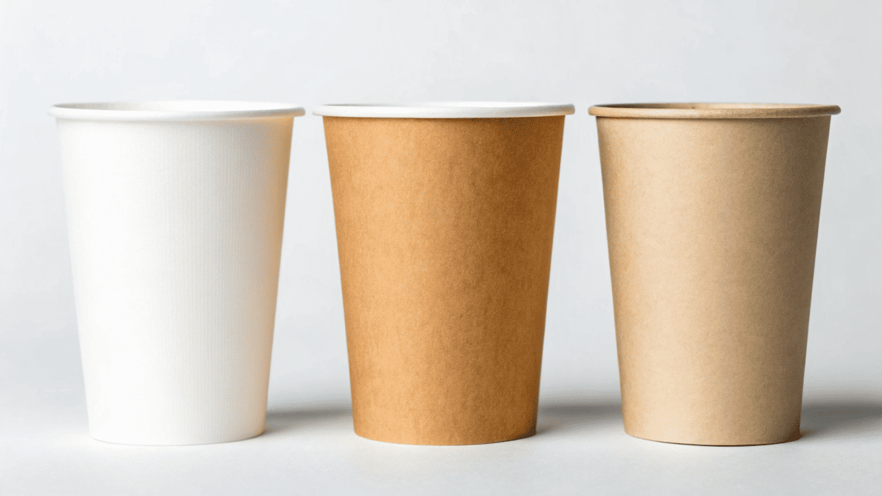 Three paper cups shown side-by-side, each with a label indicating its coating: PE, PLA, or Water-Based
