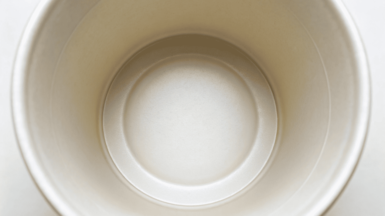 A close-up of the clean, white inner surface of a high-quality paper cup