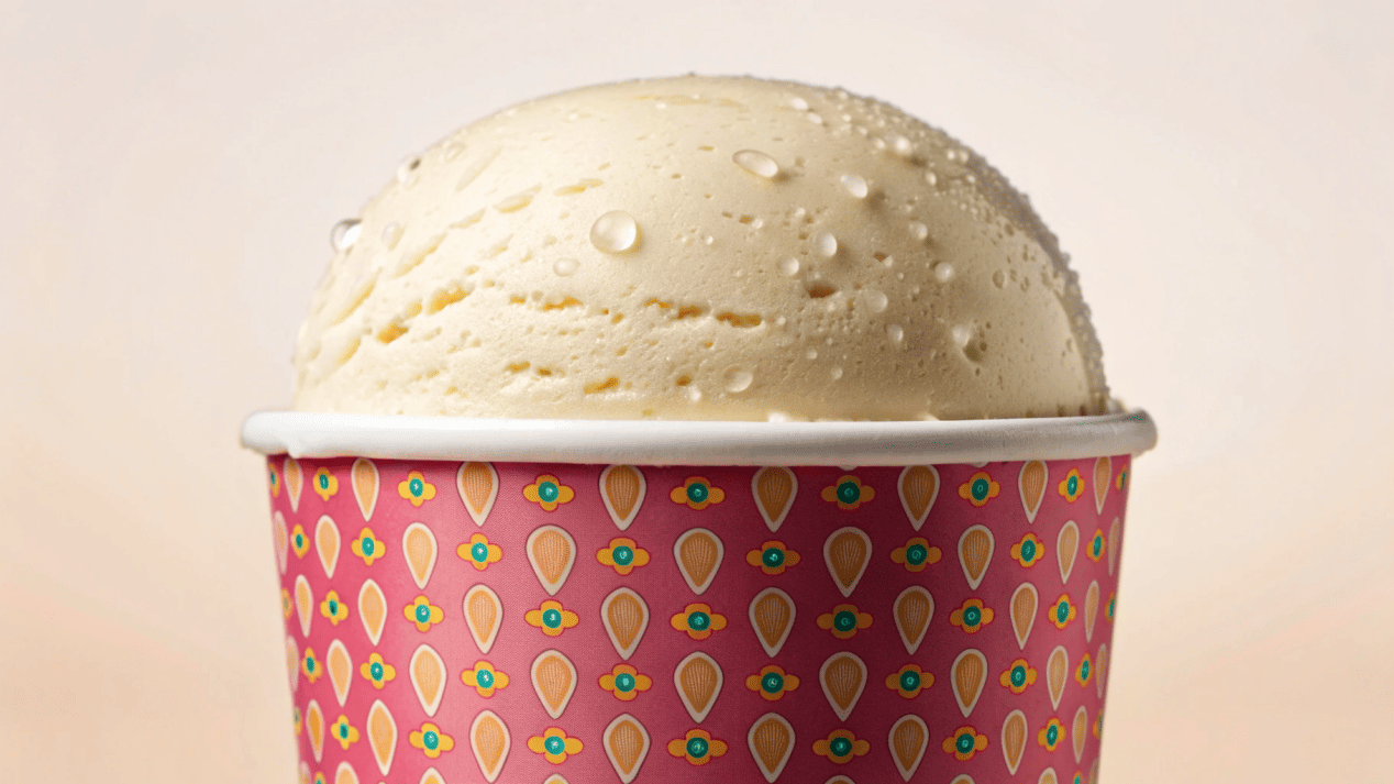 Durable Coated Paper Ice Cream Cup A coated paper ice cream cup holding a scoop of melting ice cream, with no leaks or sogginess.