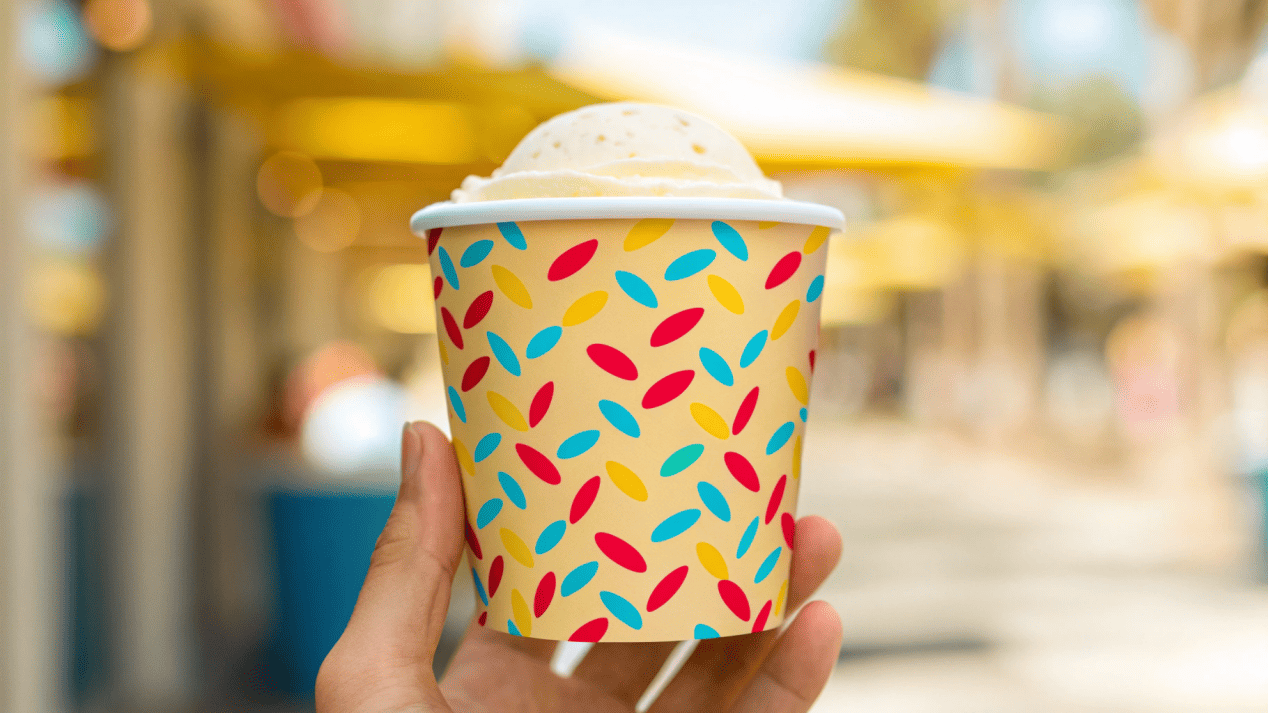 Custom Ice Cream Cups for Brand Awareness A customer holding a vibrant, custom-printed ice cream cup.