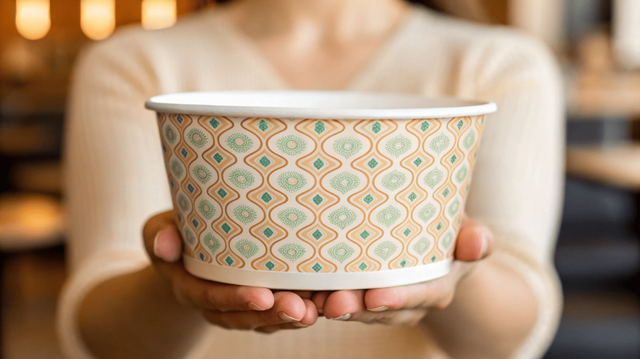 Branding on a Disposable Soup Bowl A beautifully branded soup bowl being held by a customer, clearly displaying the brand's logo and design.
