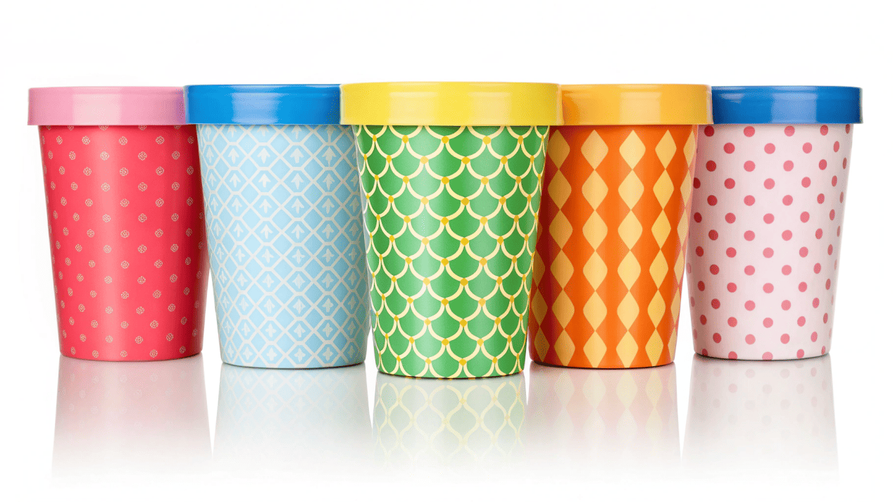 A collection of colorful, custom-printed ice cream pint containers.