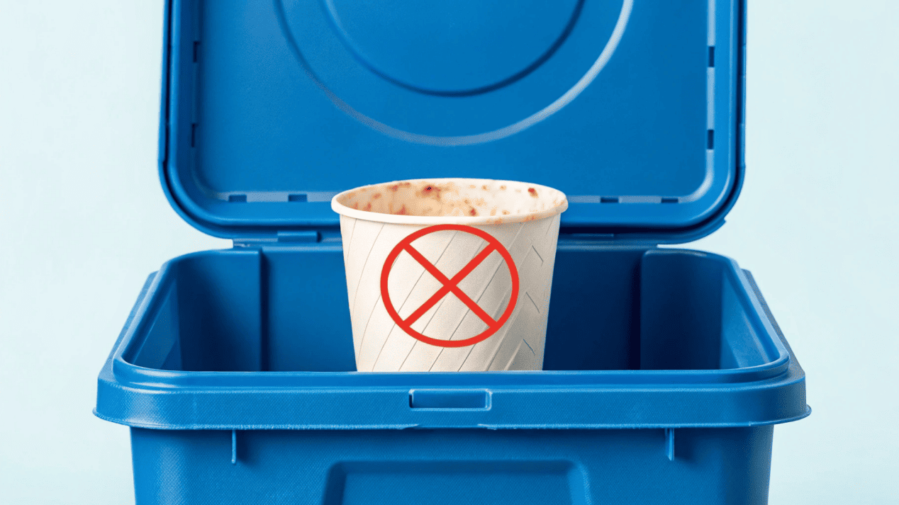 Recycling Challenges for Food Packaging An ice cream cup with residue in a recycling bin, marked with a "contamination" symbol.
