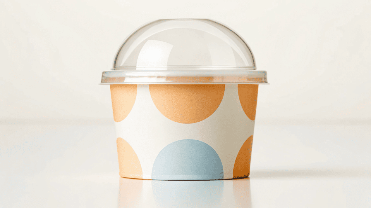 A branded ice cream cup with a clear lid, representing safety and hygiene.