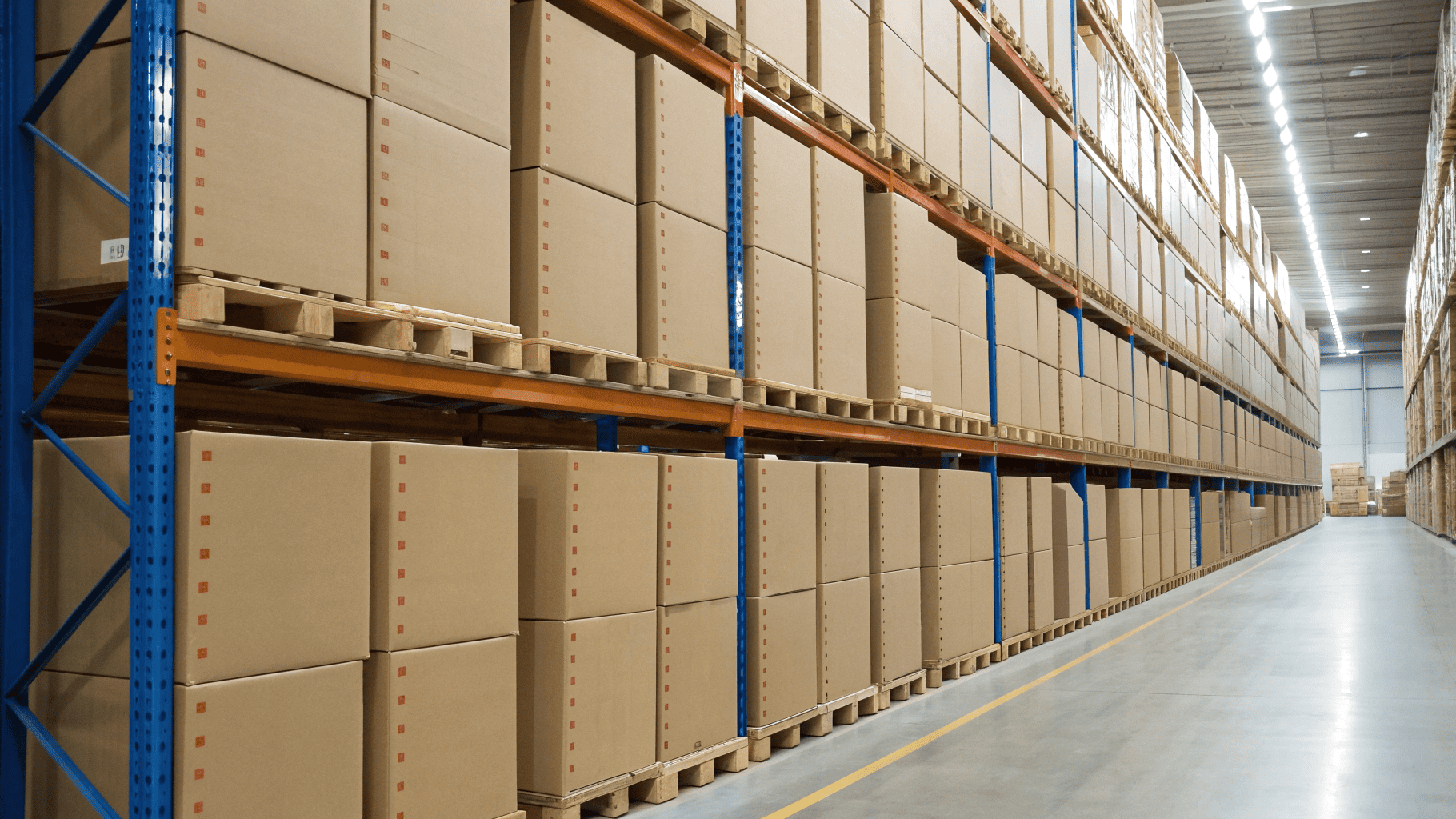 Strong, identical cardboard boxes stacked neatly and securely on a stockroom shelf.