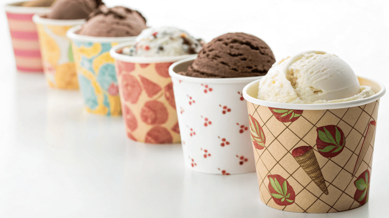 A collection of ice cream cups of different sizes with custom branding on each.