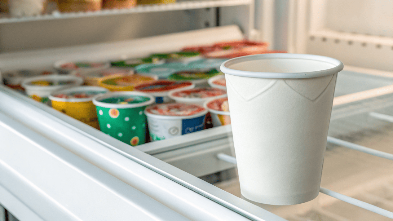 A minimalist ice cream cup standing out in a crowded freezer aisle of colorful competitors.