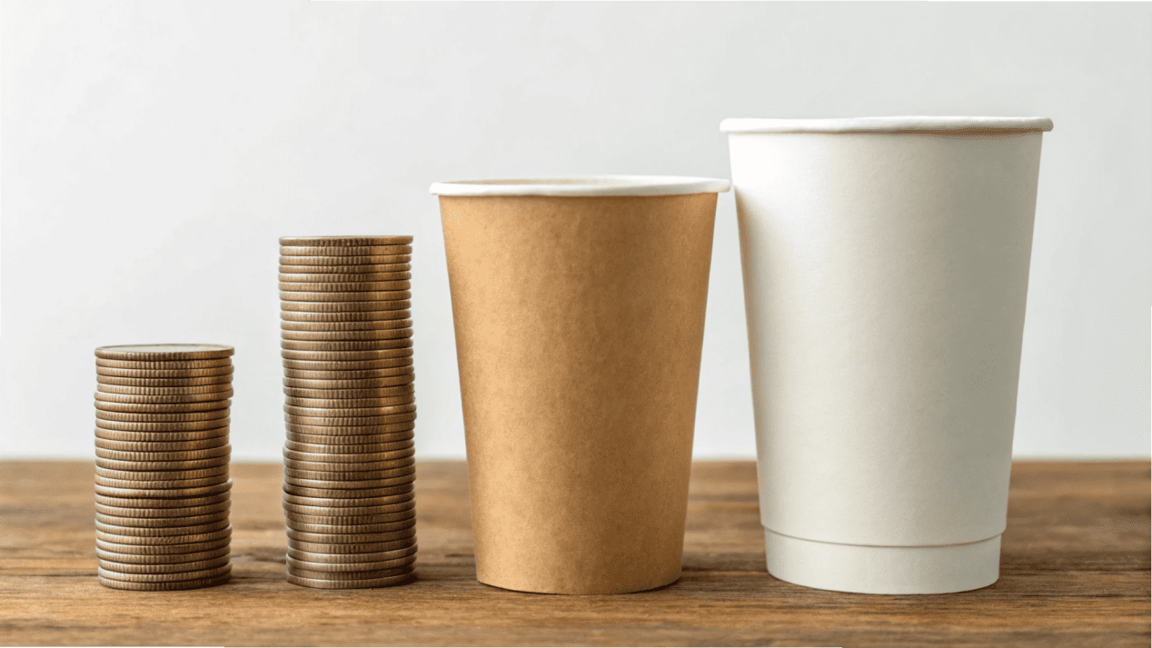 A stack of coins next to each of the three cup types, showing the relative cost increase.