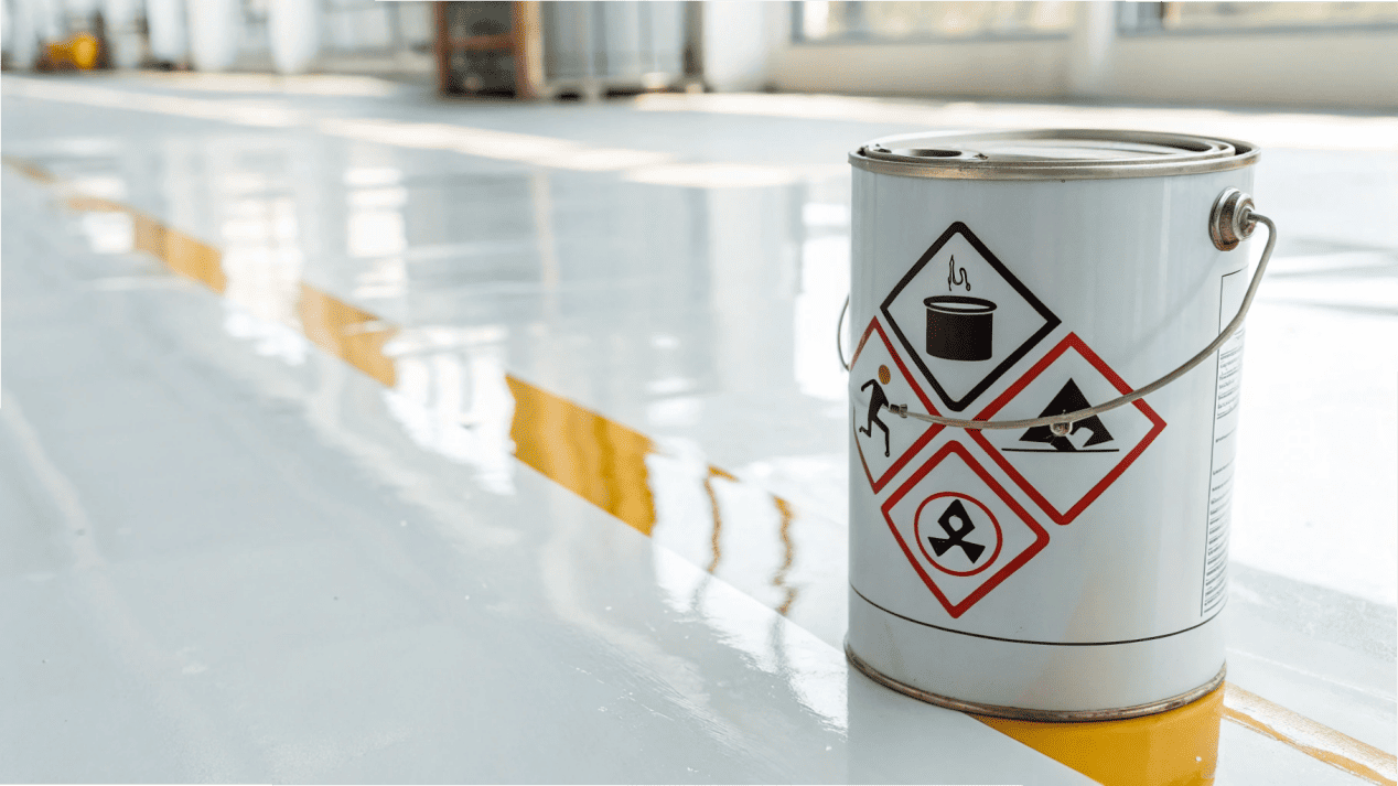 A clear warning sign over a can of acrylic sealant, indicating it is not food-safe.