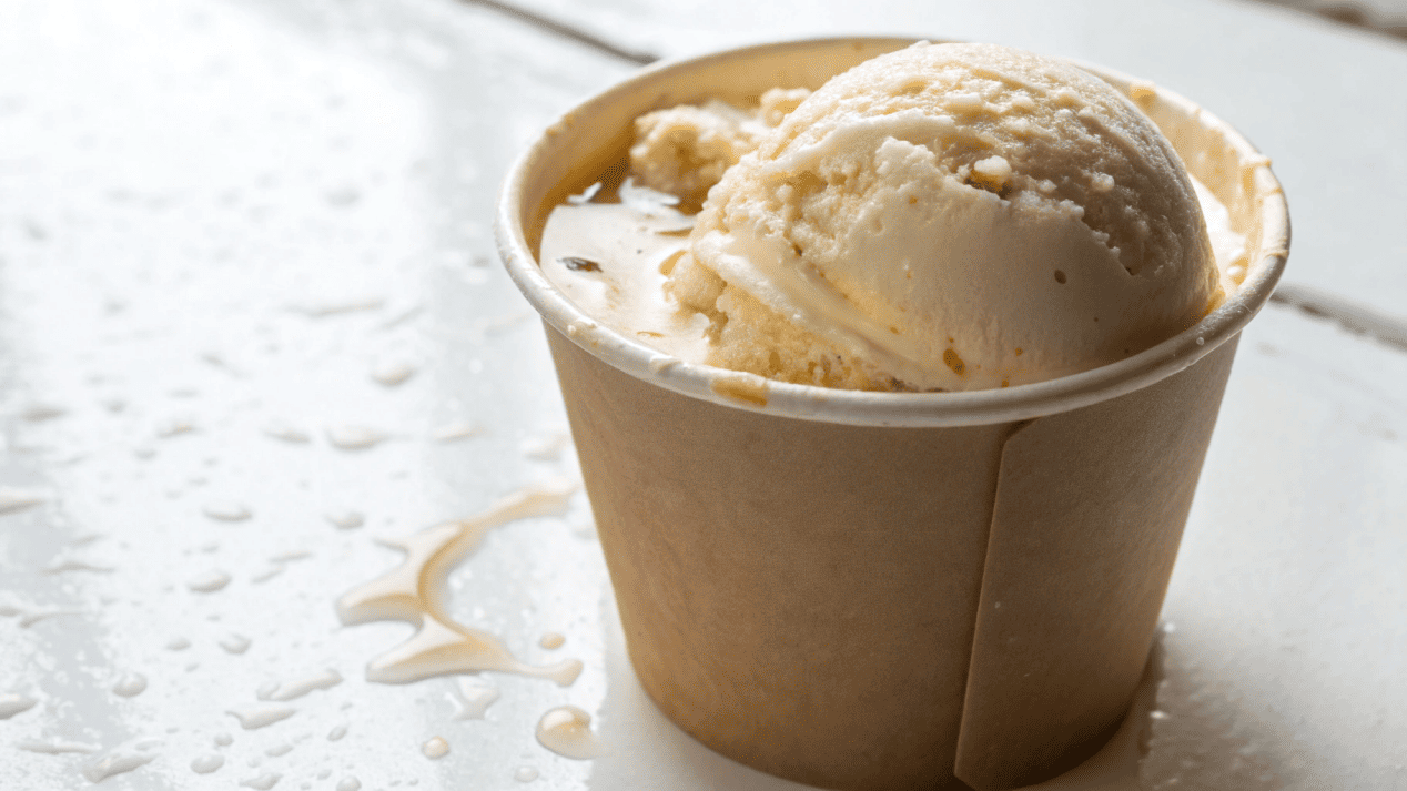 A sturdy paper ice cream cup holding melting ice cream without any sign of leakage.