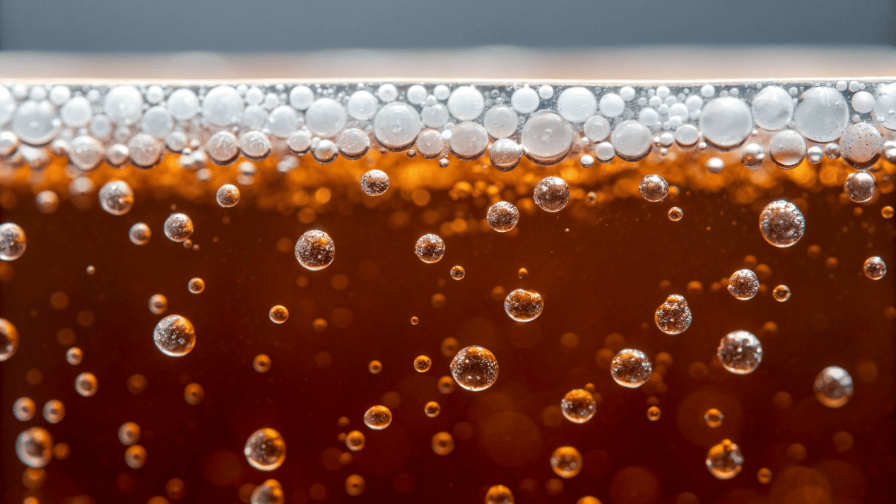 A microscopic view of microplastics floating in a beverage.